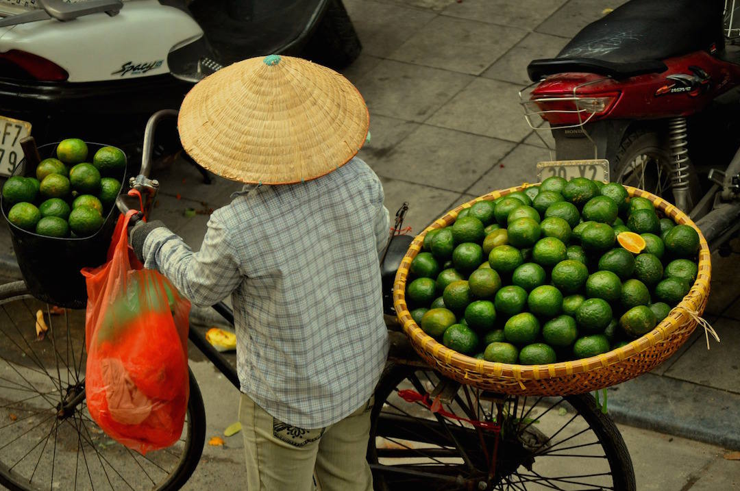 bucket list travel destinations, market woman, Hanoi, Vietnam